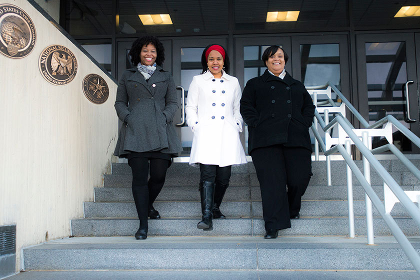 (L to R) Portrait of Dr. Aziza Jefferson, Dr. Valerie Nelson, and Dr. Philicity Williams stepping down stairs in unison in front of NSA's Fort Meade Headquarters