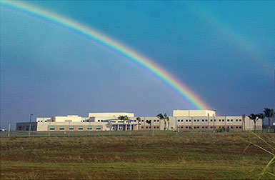 CAPT Joseph J. Rochefort Building with double rainbow in sky.